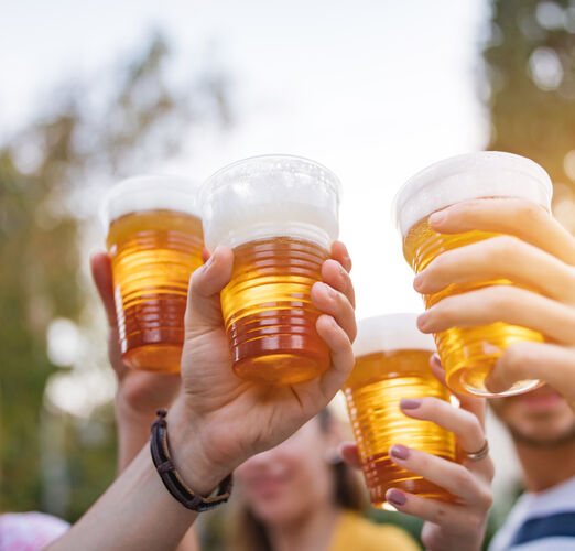 Friends,Enjoying,Drinking,Beer,In,The,Backyard.