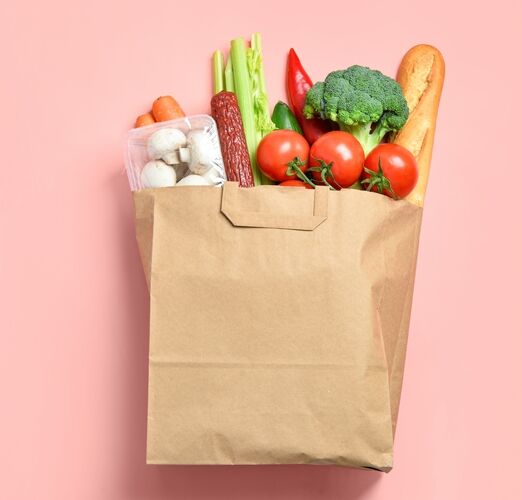 Paper,Bag,With,Different,Products,On,Pink,Background